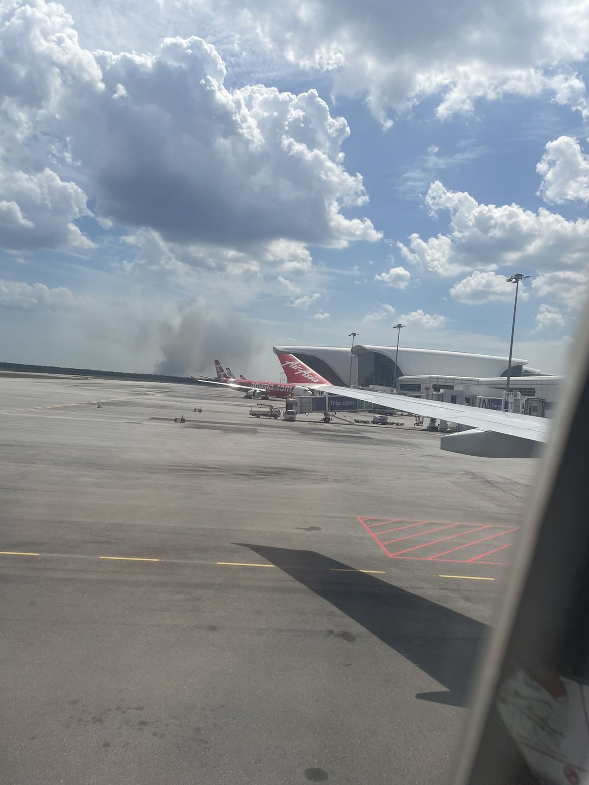 クアラルンプール空港で出発を待つ機内から見える翼と駐機場